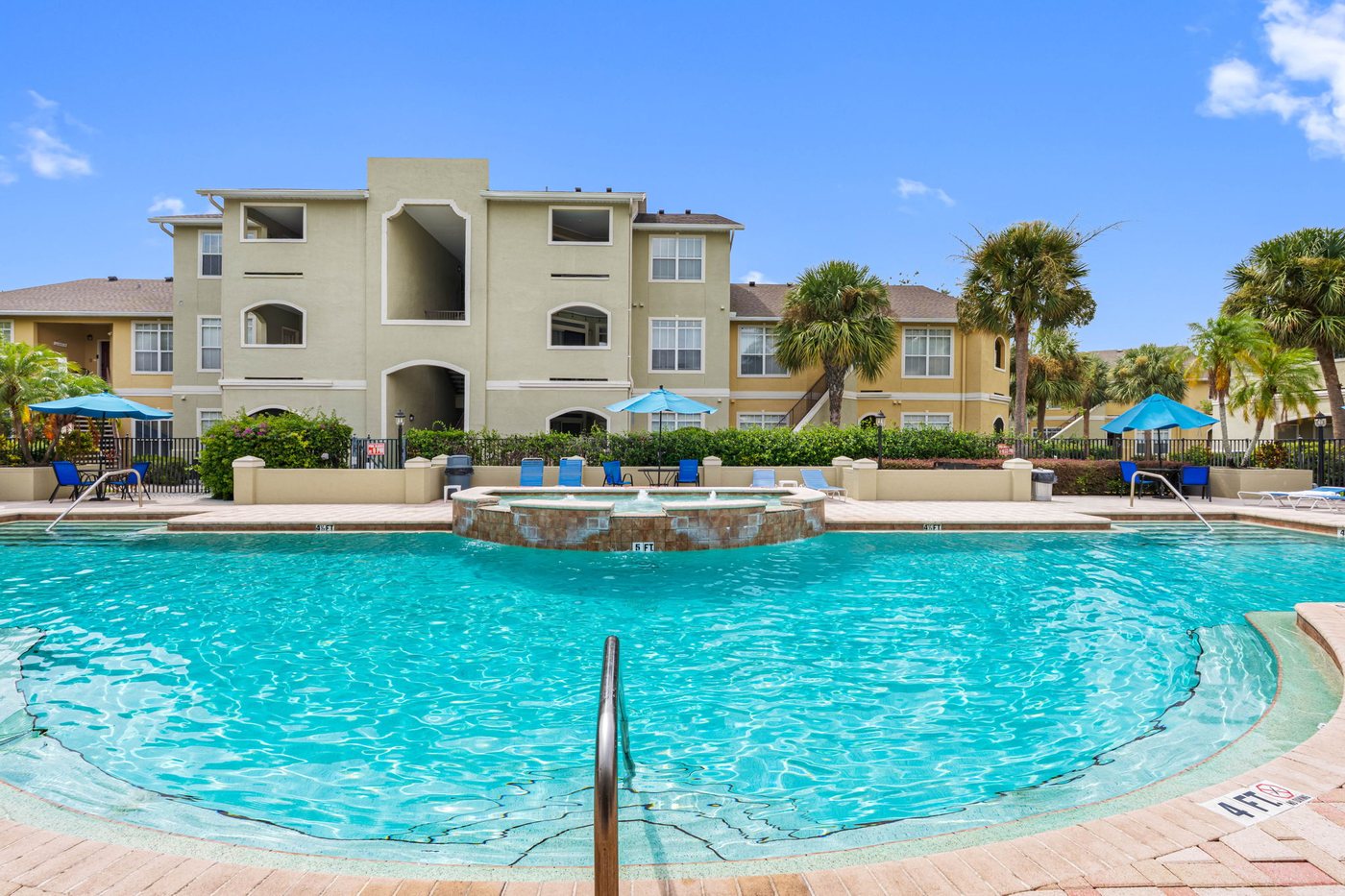 The Avalon community pool with the condo buildings and palms behind it