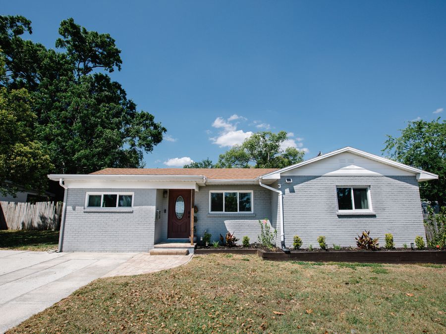 Renovated single-storey house in grey and white with new landscaping