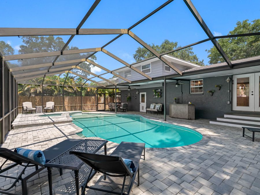 Screened pool cage with a paver deck at a Clearwater home